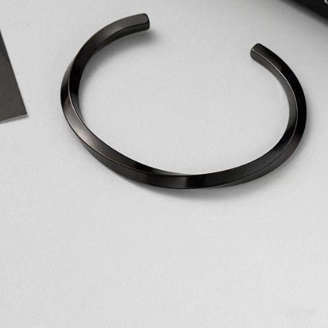 Sleek black open cuff Luxury Metal Bracelet with a minimalist design for premium men's essentials and accessories.