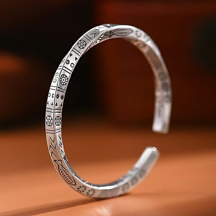 Luxury Metal Bracelet with intricate geometric and floral engravings on polished metal band