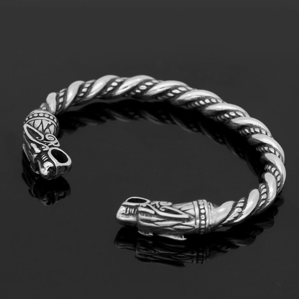 Luxury Metal Bracelet with twisted design and intricate carved end details on black background